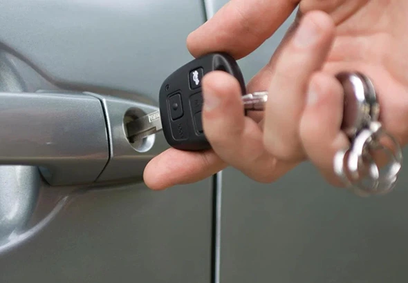 Expert locksmith cutting a duplicate key for a home or office door lock.