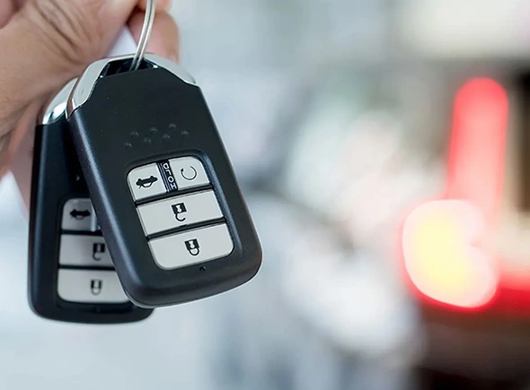 Car key fob being programmed to match the vehicle’s security system.